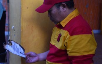 Penjagub Ismail Pakaya melihat dokumen yang terbakar di SMA Negeri 1 Boliyohuto, Kabupaten Gorontalo, Sabtu (5/8/2023). (Foto : Haris)