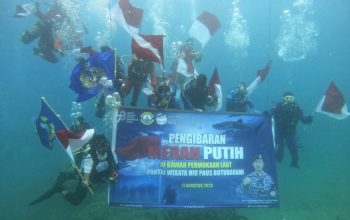 Suasana pengibaran bendera di dalam laut digelar di kawasan pantai wisata Hiu Paus Botubarani, Kecamatan Kabila Bone, Kabupaten Bone Bolango